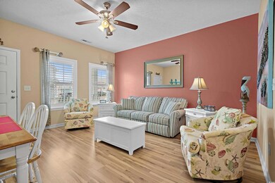 Living room with a textured ceiling, light hardwoo