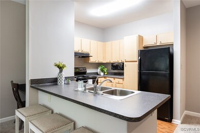 Kitchen with black appliances, under cabinet range