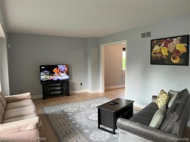 Living area with wood finished floors and baseboards