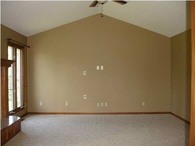 Great Room has vaulted ceiling, fan, and lots of w