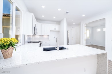 Kitchen with a sink, stainless steel appliances, l
