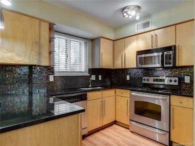 Kitchen has tile backsplash, granite countertops a