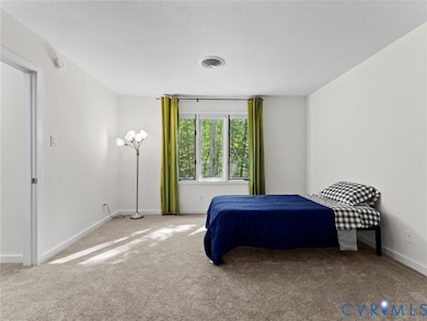 Carpeted bedroom featuring baseboards
