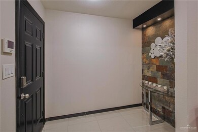 Corridor featuring light tile patterned floors