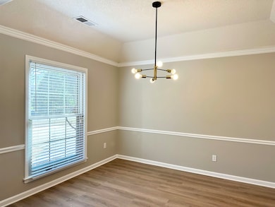 Spare room featuring a textured ceiling, visible v