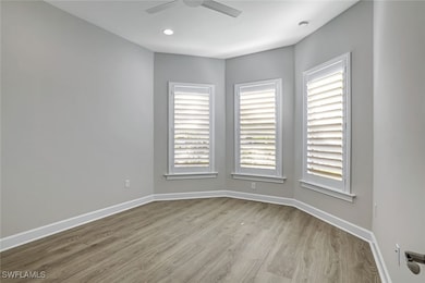 Spare room with wood finished floors, recessed lighting, and ceiling fan