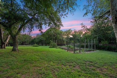 Yard at dusk with a vegetable garden and a lawn
