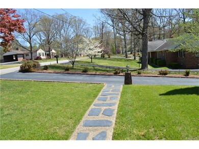 Paved driveway lined with brick.