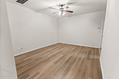 Spare room with light wood finished floors and ceiling fan