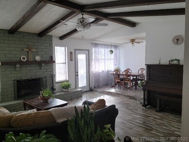 Living with wood burning fireplace and dining. Bac