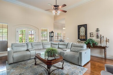 Living room featuring french doors, crown molding,