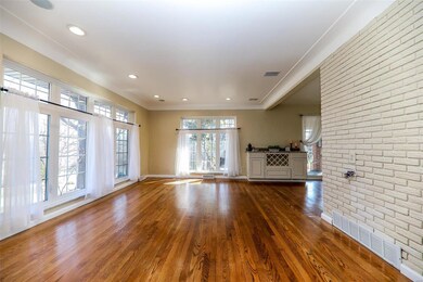Gorgeous hardwoods in living room with expansive windows and coved ceilings. Freshly painted main level.