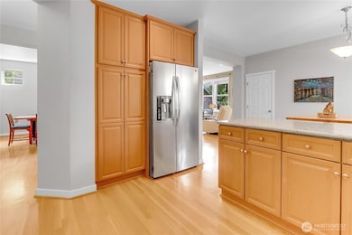 Newer stainless steel appliances highlight the kitchen, including a café door refrigerator, built-in microwave and a five-burner gas cooktop which makes cooking at home easy and enjoyable.