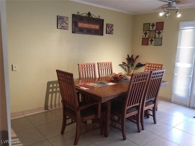 Dining area with crown molding, a ceiling fan, and