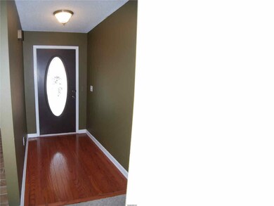 Entry foyer features hardwood flooring