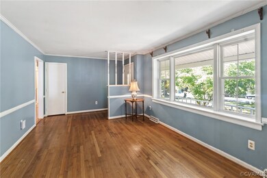 Spare room with a baseboard radiator, crown moldin