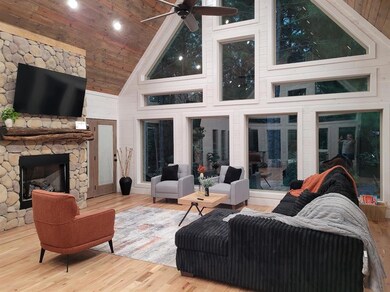 Living room featuring ceiling fan, light hardwood 