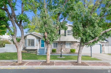 View of front of home featuring stone siding, stucco siding, concrete driveway, and a garage