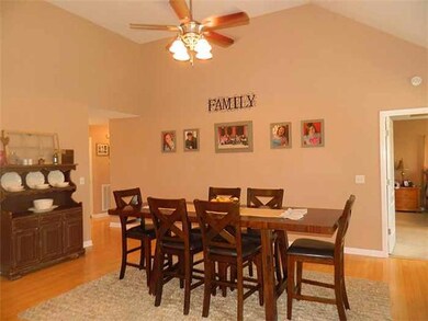 Greatroom - 15 x 18, currently being used for a larger dining area—this area offers hardwood floors, vaulted ceiling and a gas log fireplace - and opens to the Kitchen & Dining Area.  