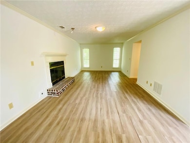 Unfurnished living room featuring visible vents, c