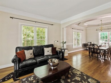 Formal Living Room with Hardwood Floors and Triple