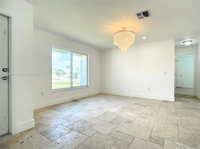Front door entry to living space showing large impact windows.  This space leads to 2 bedrooms and one bath.
