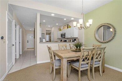 Dining room featuring recessed lighting, light carpet, baseboards, visible vents, and a notable chandelier