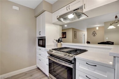 The kitchen features custom cabinets and a high en