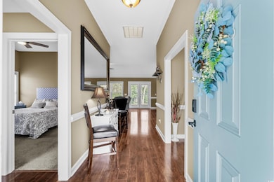 Entryway with ceiling fan, visible vents, baseboar