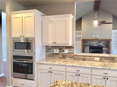 Custom painted cabinets , beautiful granite countertops & stone tumble marble backsplash.