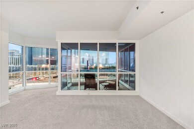 Carpeted spare room featuring a view of city and b