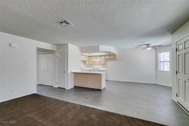 Unfurnished living room featuring ceiling fan, til