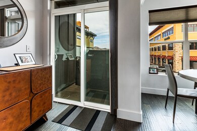 Bathroom with dark wood-style flooring and a shower stall