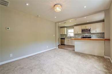 Kitchen featuring visible vents, recessed lighting