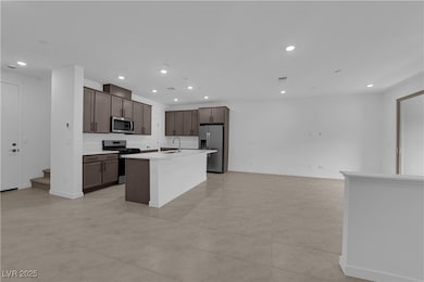 Kitchen featuring stainless steel appliances, a si