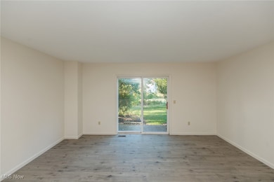Unfurnished room featuring light wood-type flooring and baseboards
