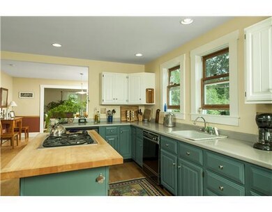 Kitchen. Hardwood floors run...