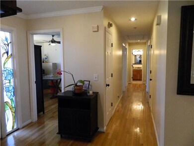 Entry foyer with hardwood floors and stained glass windows.