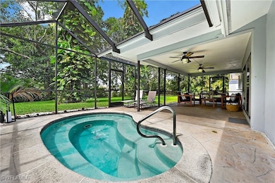View of swimming pool featuring ceiling fan, glass enclosure, a patio, and a sunroom