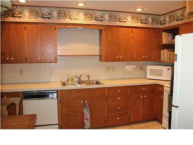 Kitchen view shows tile backsplash