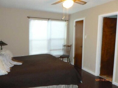 Master Bedroom. King size bed, concrete floor