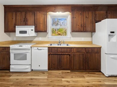 Kitchen w/ White Appliances, Disposal & Updated Luxury Vinyl Flooring