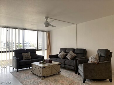 Living area featuring ceiling fan and light tile p