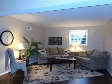 The den/family room with bright windows and new paint throughout!