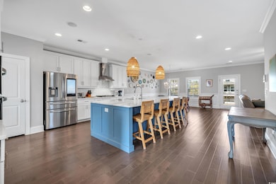 Kitchen with wall chimney exhaust hood, visible ve