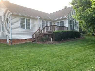 Another view of back of home showing well manicure