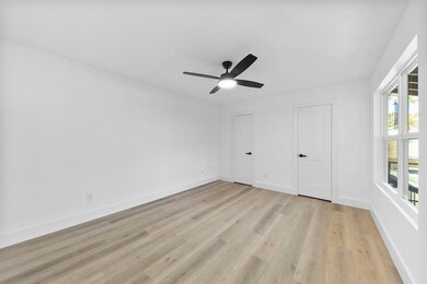 Bright and spacious room with light wood flooring