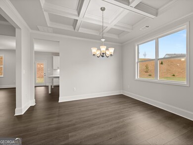 Westerly open dining room with a chandelier and coffered ceilings