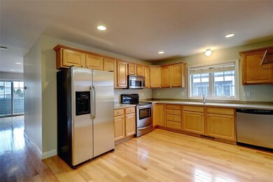 Open Kitchen with Stainless Applicances and Maple