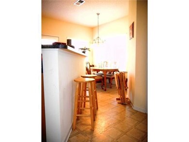 THE BREAKFAST BAR SEPARATES THE KITCHEN FROM THE D